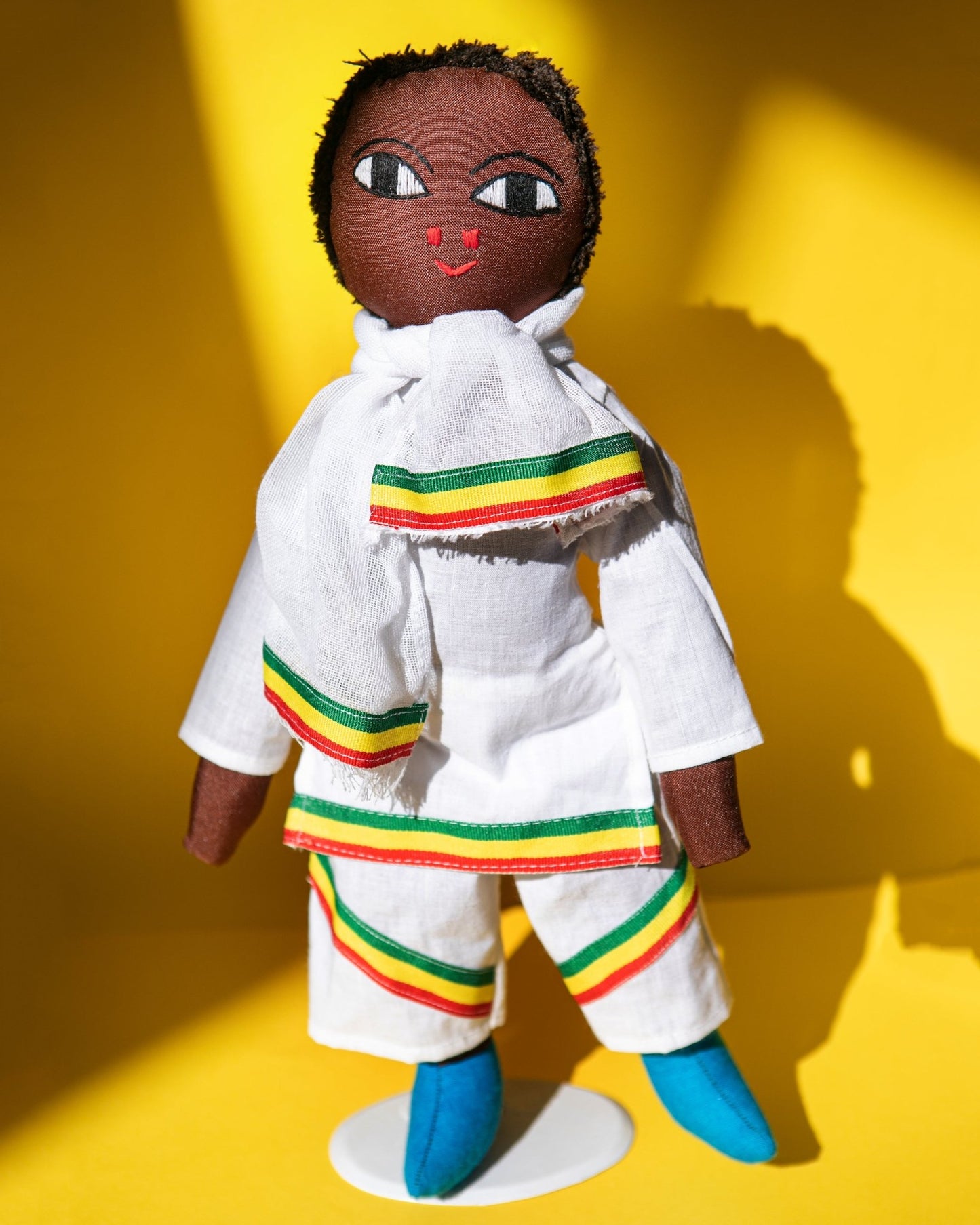Handmade Ethiopian doll with red, green, yellow, white clothing