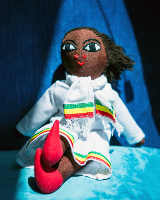 Handmade Ethiopian doll with red, green, yellow, white clothing