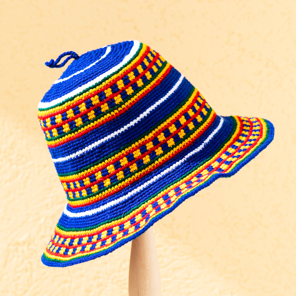 Handmade Konso crochet wide brim hat from Ethiopia in blue, red, yellow, green and white geometric patterns.
