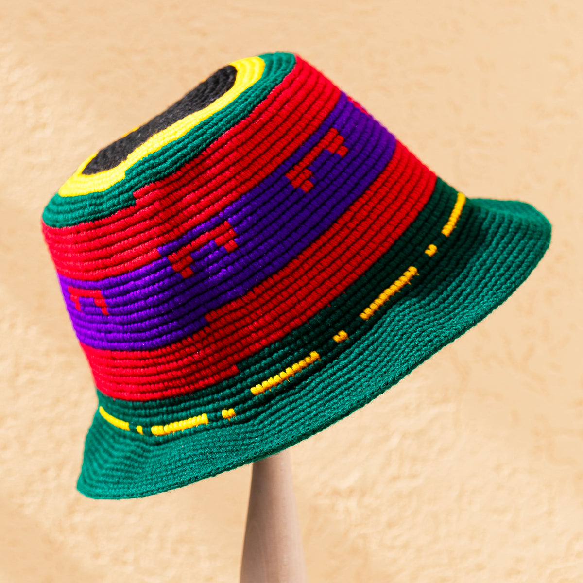 Green Konso crochet wide brim hat handmade in Ethiopia with bold red, purple, yellow and black geometric details.