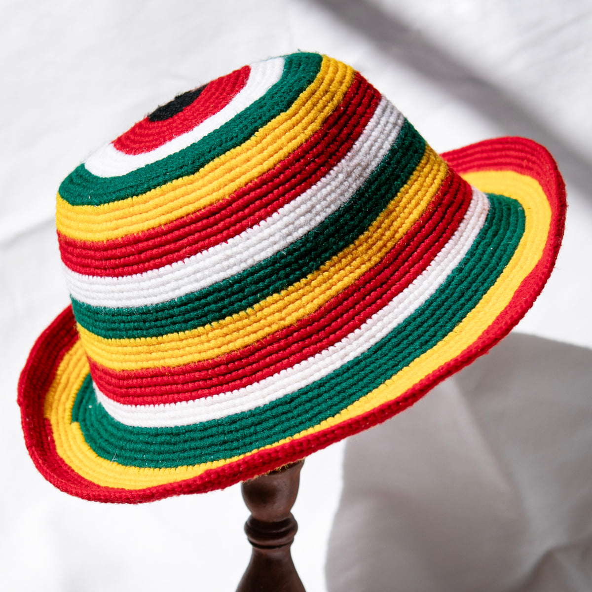 Red gold and green Rasta color Konso crochet wide brim hat handmade in Ethiopia with white and black striped accents.